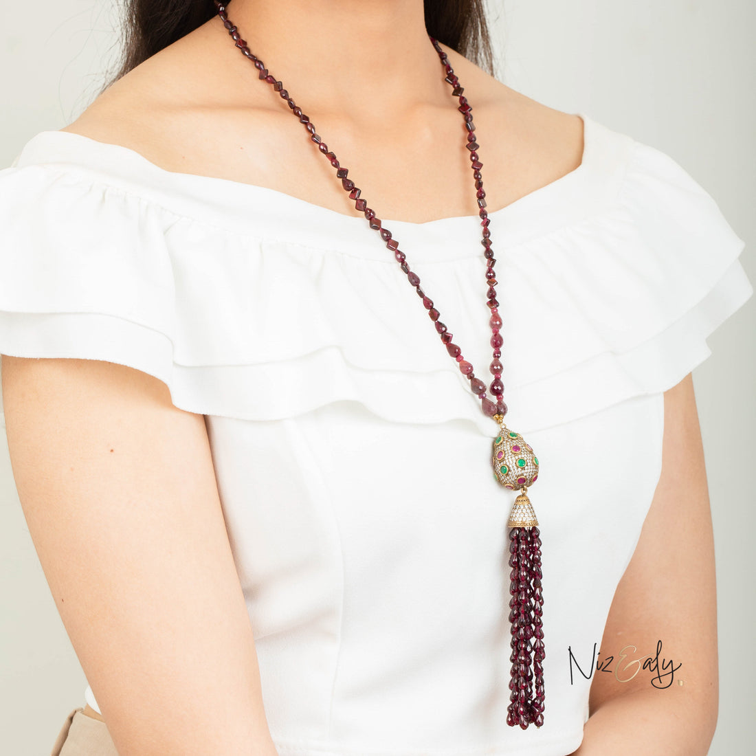 Niz & Aly Mozambique almandine garnet tassel necklace featuring ruby accents and a decorative jeweled pendant