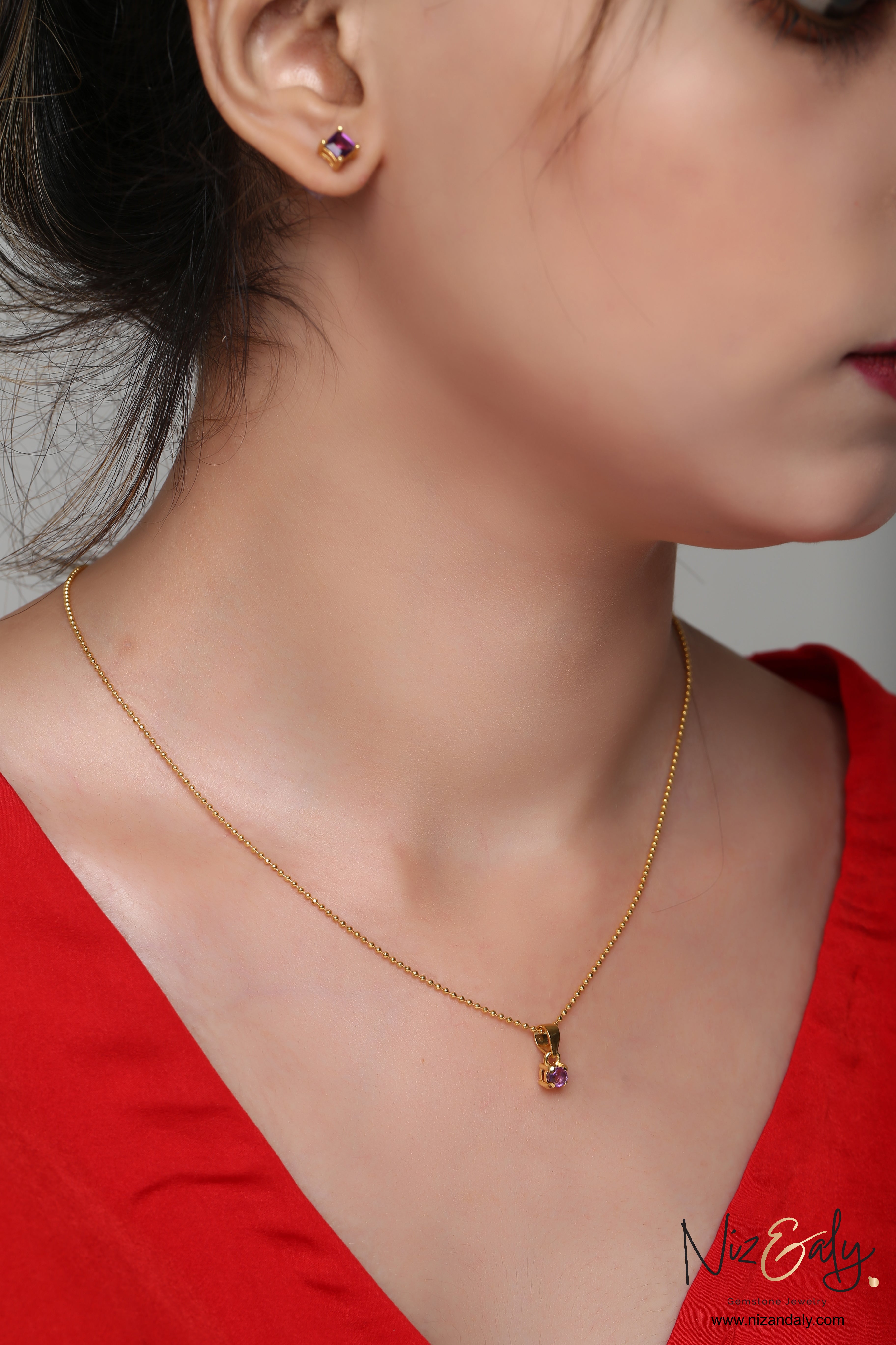 Niz & Aly dainty gold-plated necklace and stud earring set featuring square faceted natural amethyst stones.