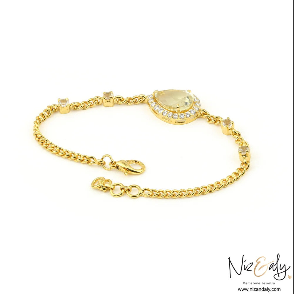 Niz & Aly gold-plated sterling silver bracelet featuring a teardrop clear quartz stone surrounded by sparkling crystals.