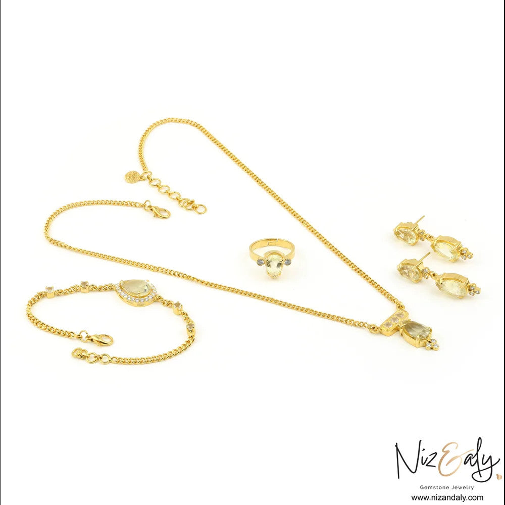 Niz & Aly gold-plated 925 sterling silver jewelry set with faceted teardrop clear quartz pendant, ring, and bracelet.
