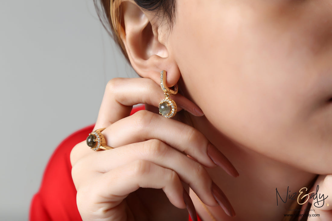 Niz & Aly gold-plated round labradorite earring and ring set with sparkling stone accents worn by a woman