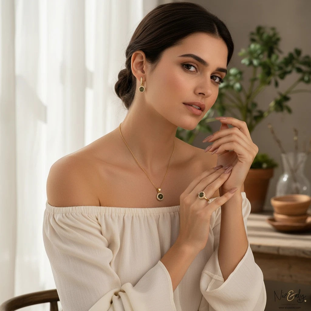 Niz & Aly gold-plated round labradorite pendant necklace and matching earrings worn by a woman in a white top.
