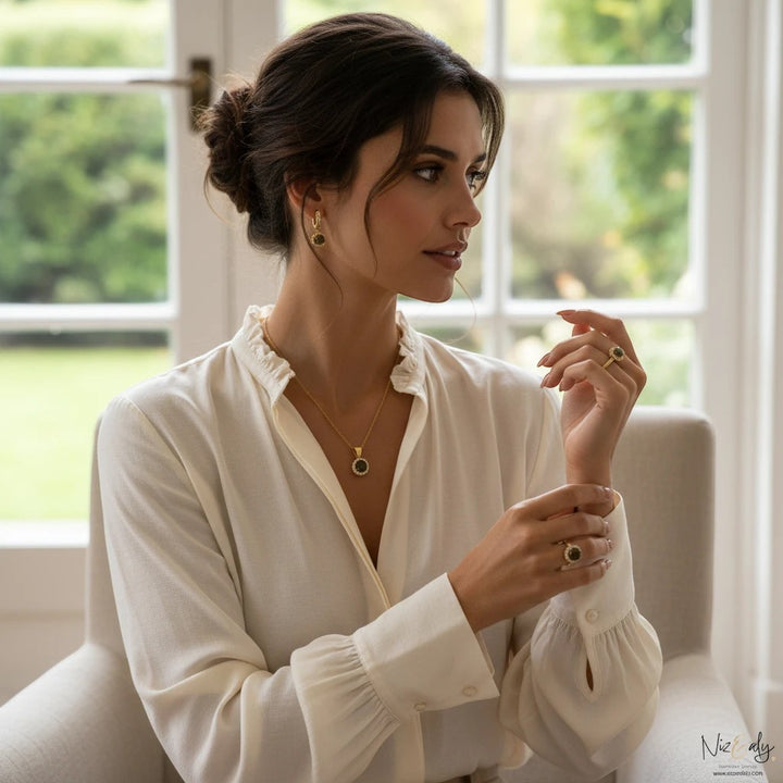 Niz & Aly gold-plated round labradorite pendant set with matching earrings worn by a woman in a white blouse.