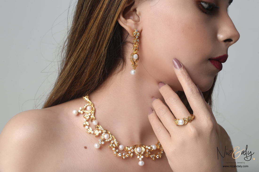 Niz & Aly bridal gold-plated sterling silver necklace set with freshwater pearls and matching earrings on a model