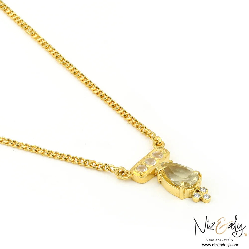 Niz & Aly gold-plated sterling silver necklace featuring a teardrop clear quartz pendant with accent stones.