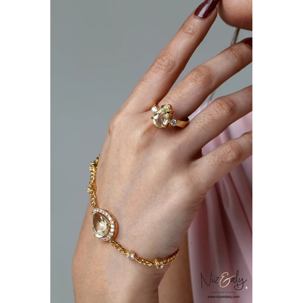 Niz & Aly gold-plated sterling silver jewelry set featuring faceted teardrop clear quartz on a ring and bracelet.