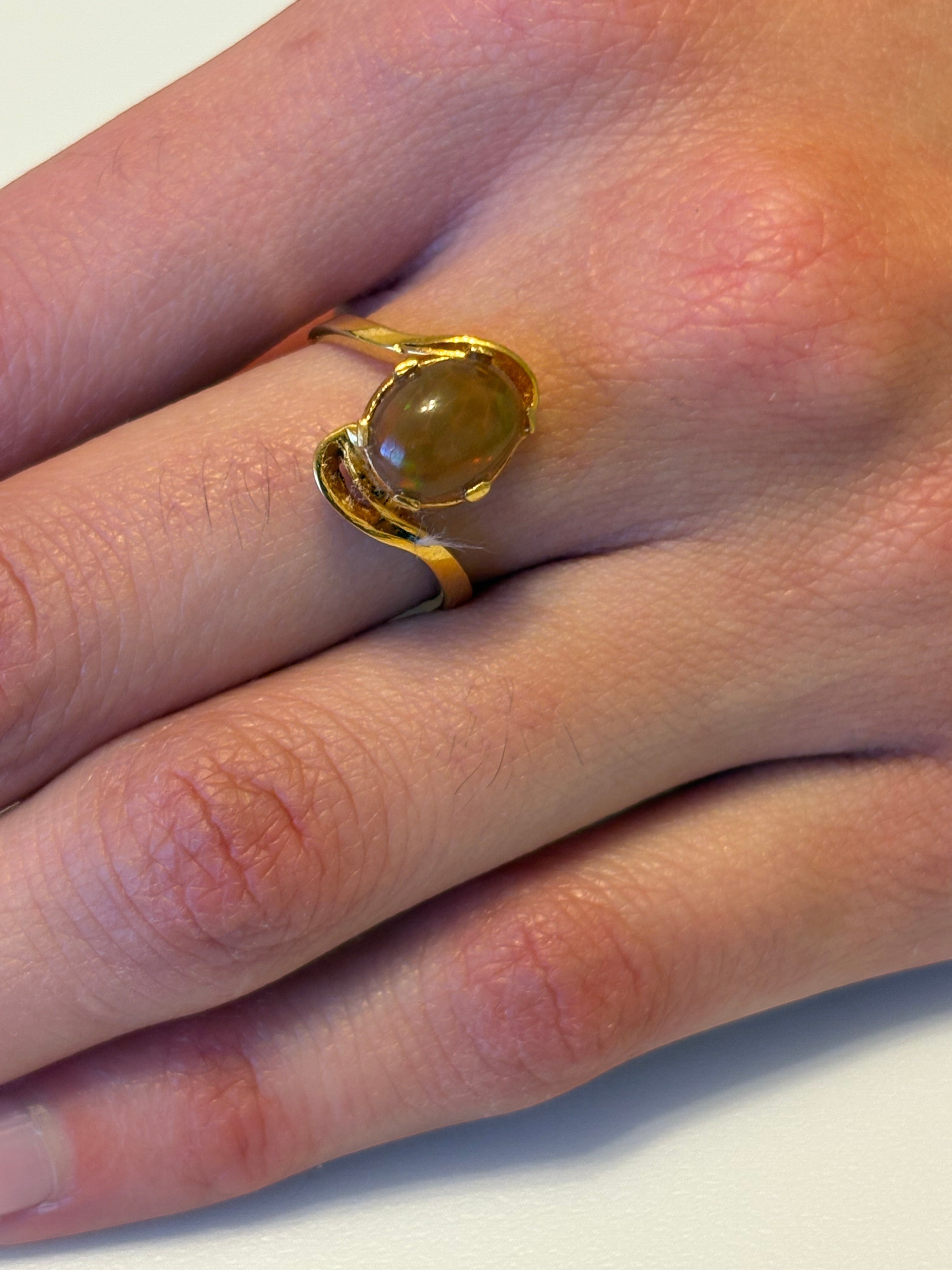 Niz & Aly adjustable ring featuring a golden fire opal set in gold-plated sterling silver on a finger