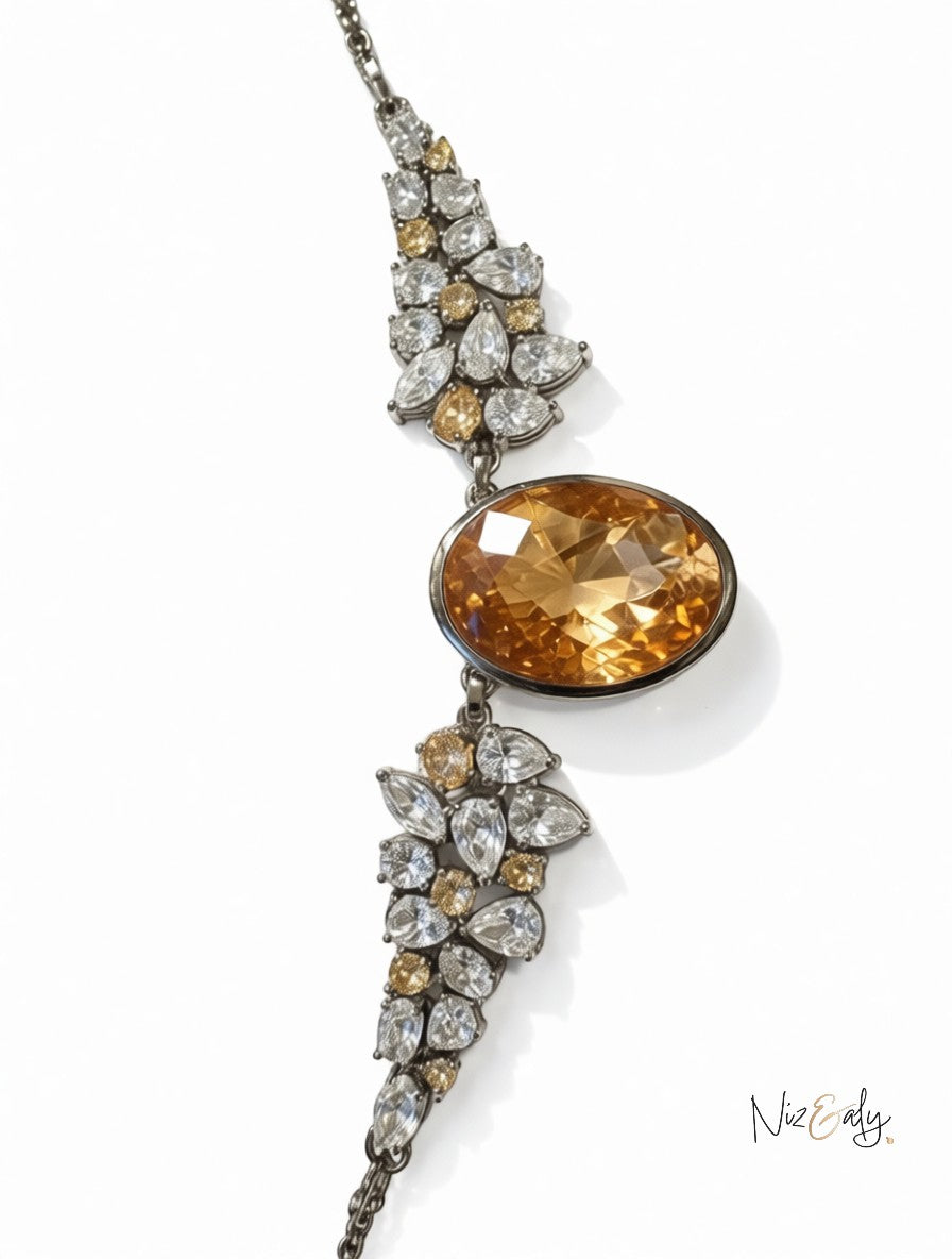 Niz & Aly Golden Hour statement necklace featuring a large champagne zirconia oval pendant with clear crystal accents.