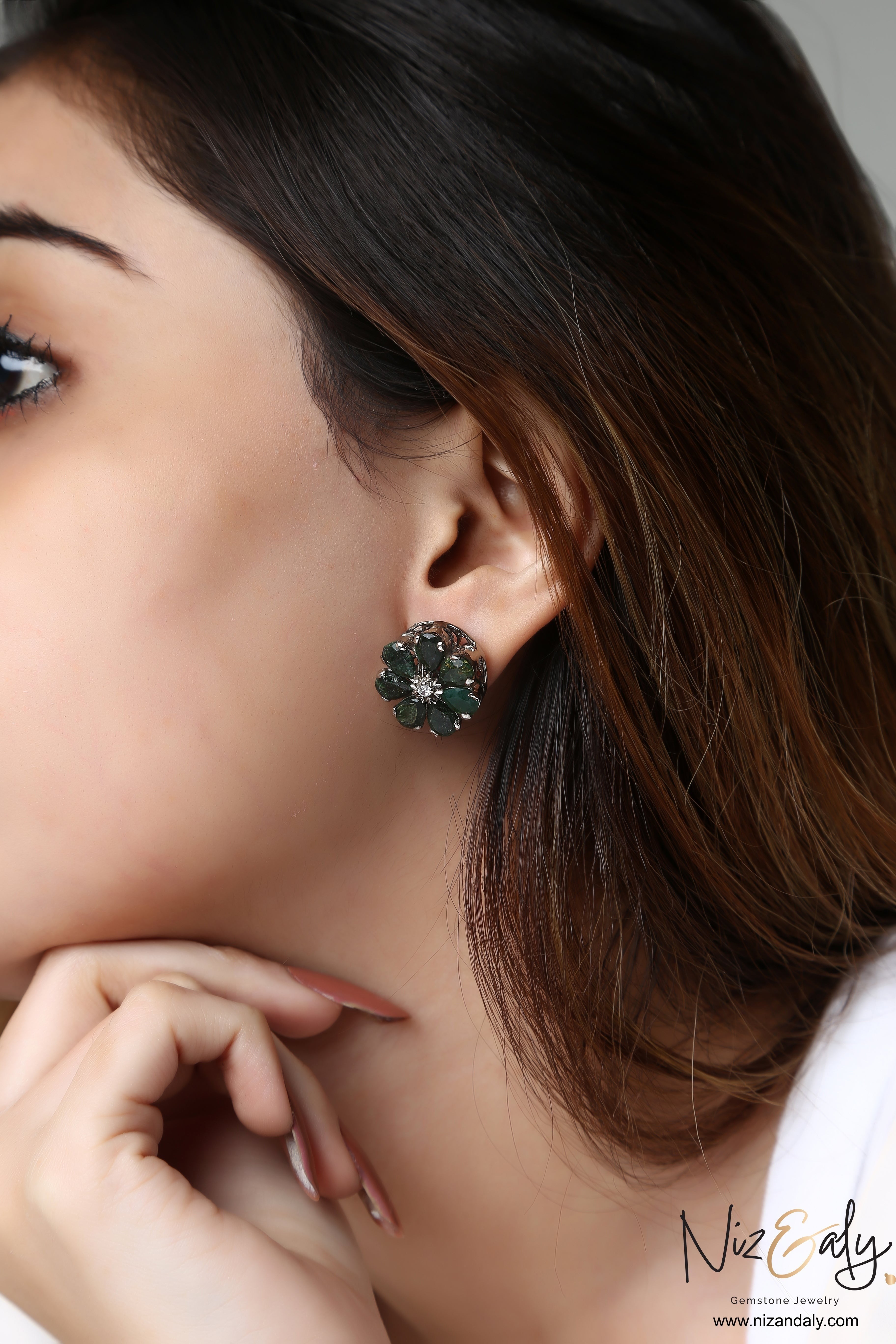 Niz & Aly green chrysoprase flower-shaped ear studs worn by a woman, featuring a delicate floral gemstone design.