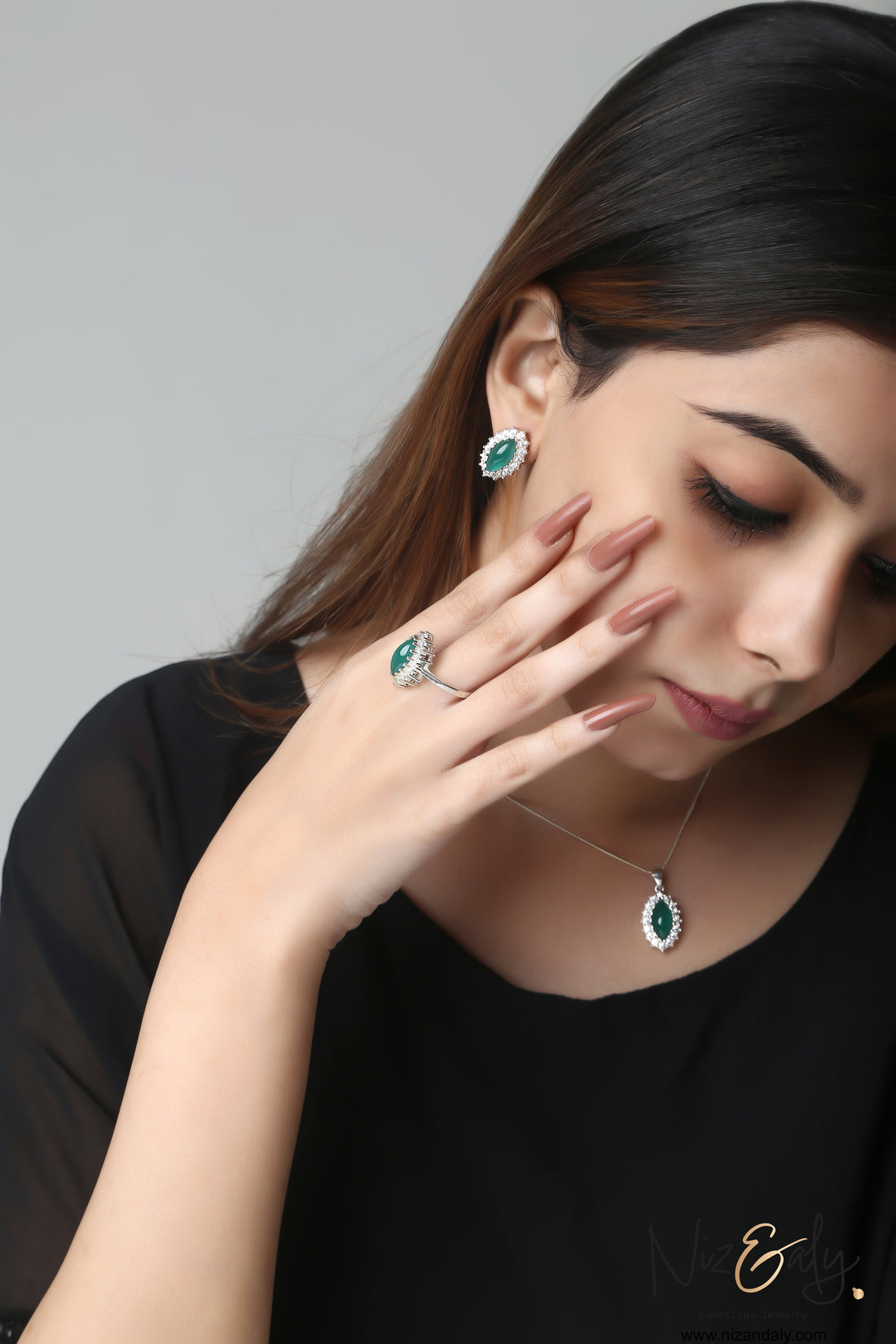 Niz & Aly marquise cut green chrysoprase pendant and earring set worn by a woman with a matching ring