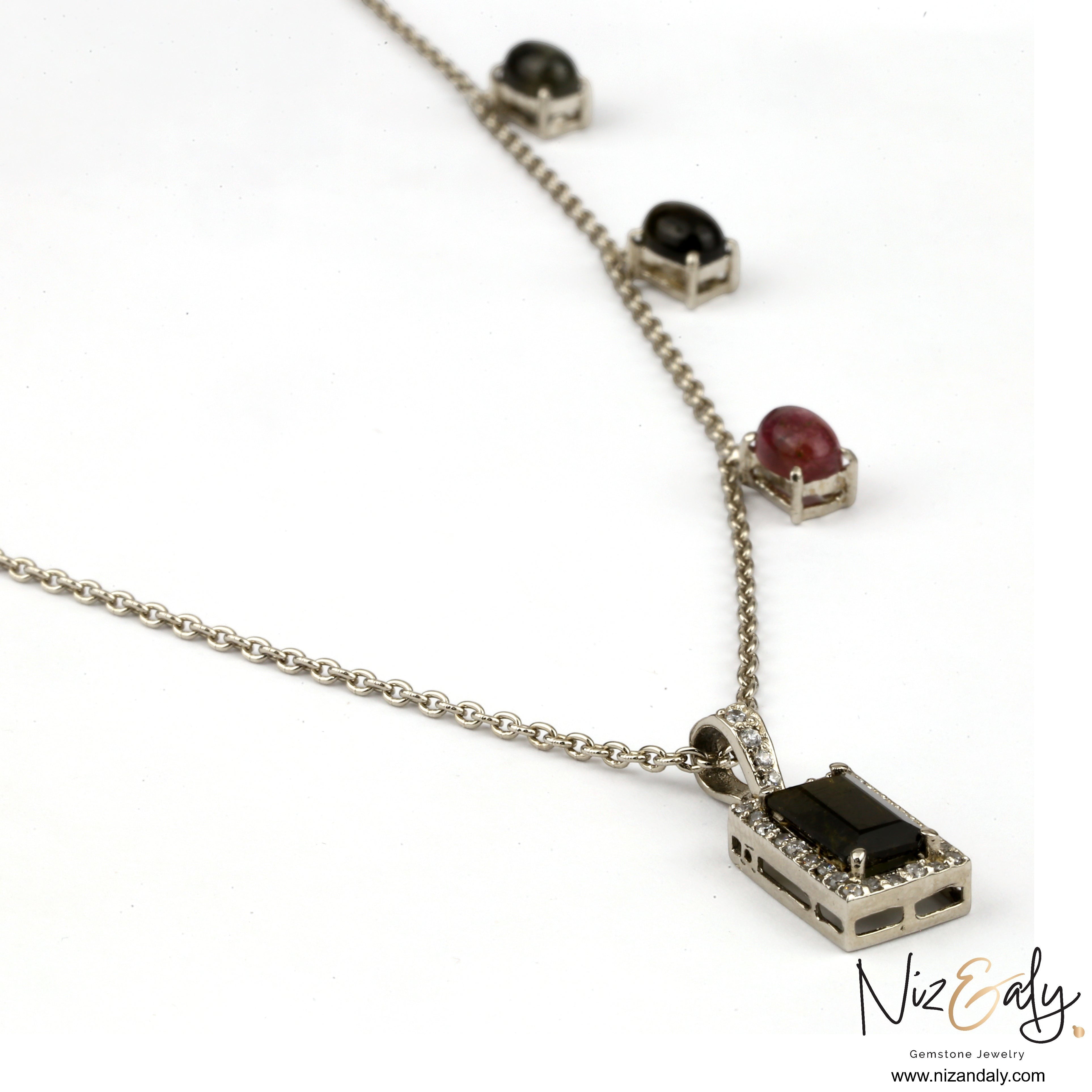 Niz & Aly green tourmaline pendant necklace with diamond accents and multi-gemstone chain on a silver setting.