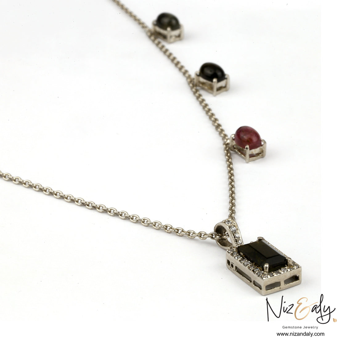 Niz & Aly green tourmaline pendant necklace with diamond accents and multi-gemstone chain on a silver setting.