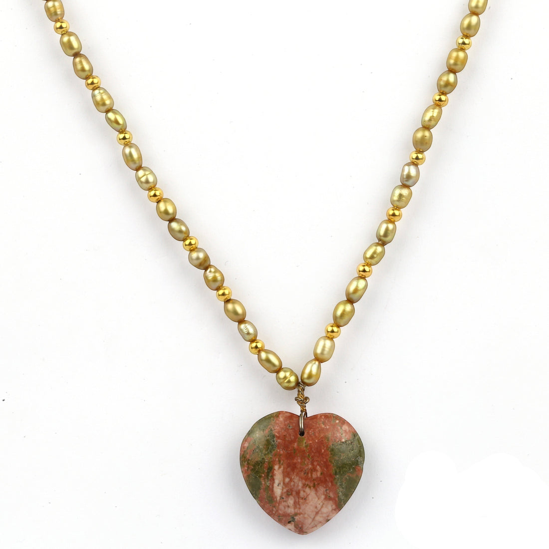 Niz & Aly necklace featuring gold-toned beads and a heart-shaped red and green gemstone pendant