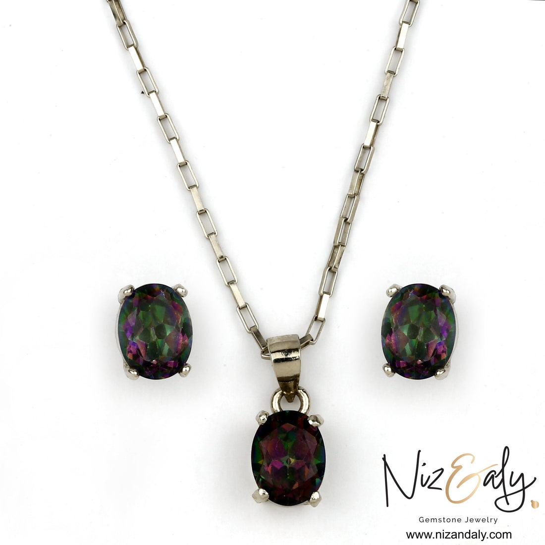 Niz & Aly oval solitaire iolite pendant and earring set in silver, featuring deep blue-violet iridescent gemstones.