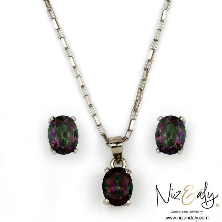 Niz & Aly oval solitaire iolite pendant and earring set in silver, featuring deep blue-violet iridescent gemstones.