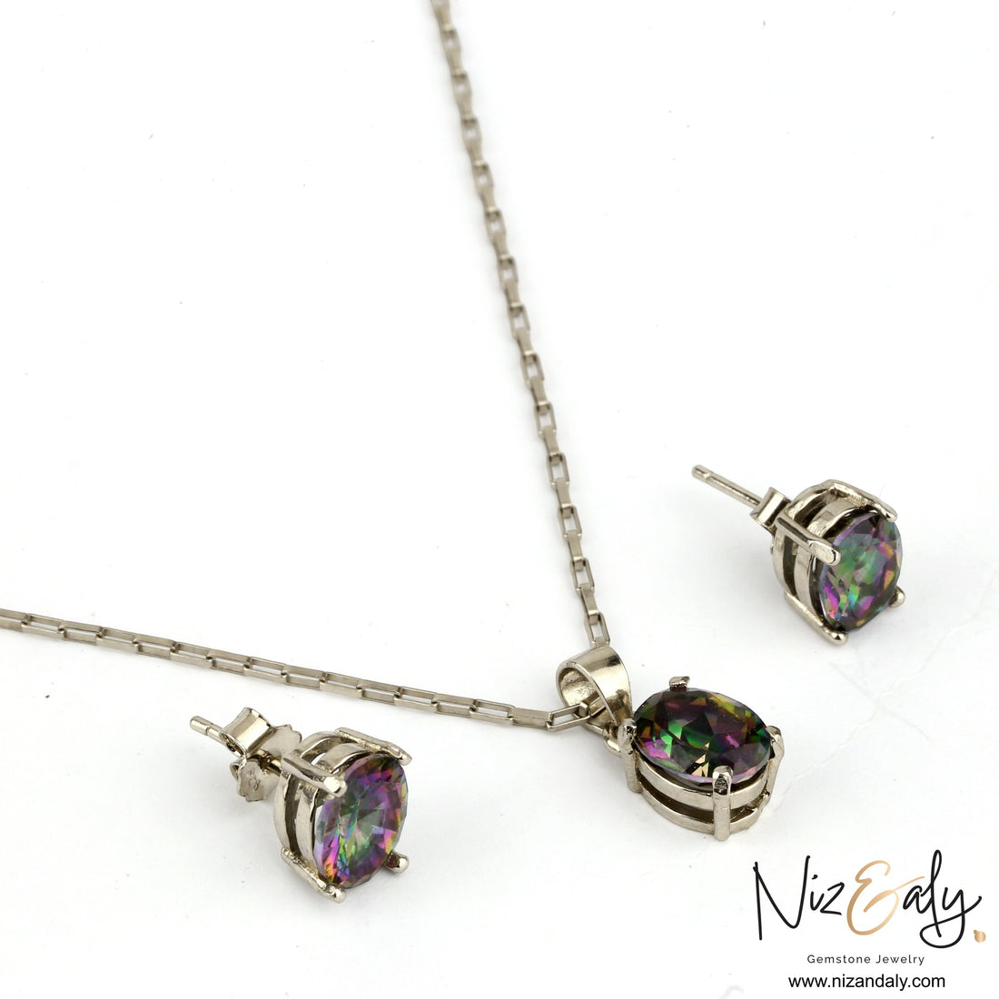 Niz & Aly solitaire pendant and earring set featuring iridescent oval iolite gemstones in a silver setting
