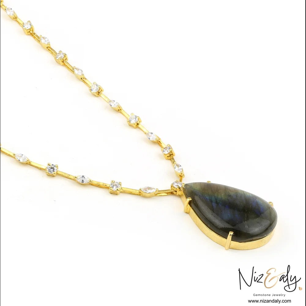 Niz & Aly teardrop labradorite pendant necklace with a gold-toned chain studded with sparkling white crystals.