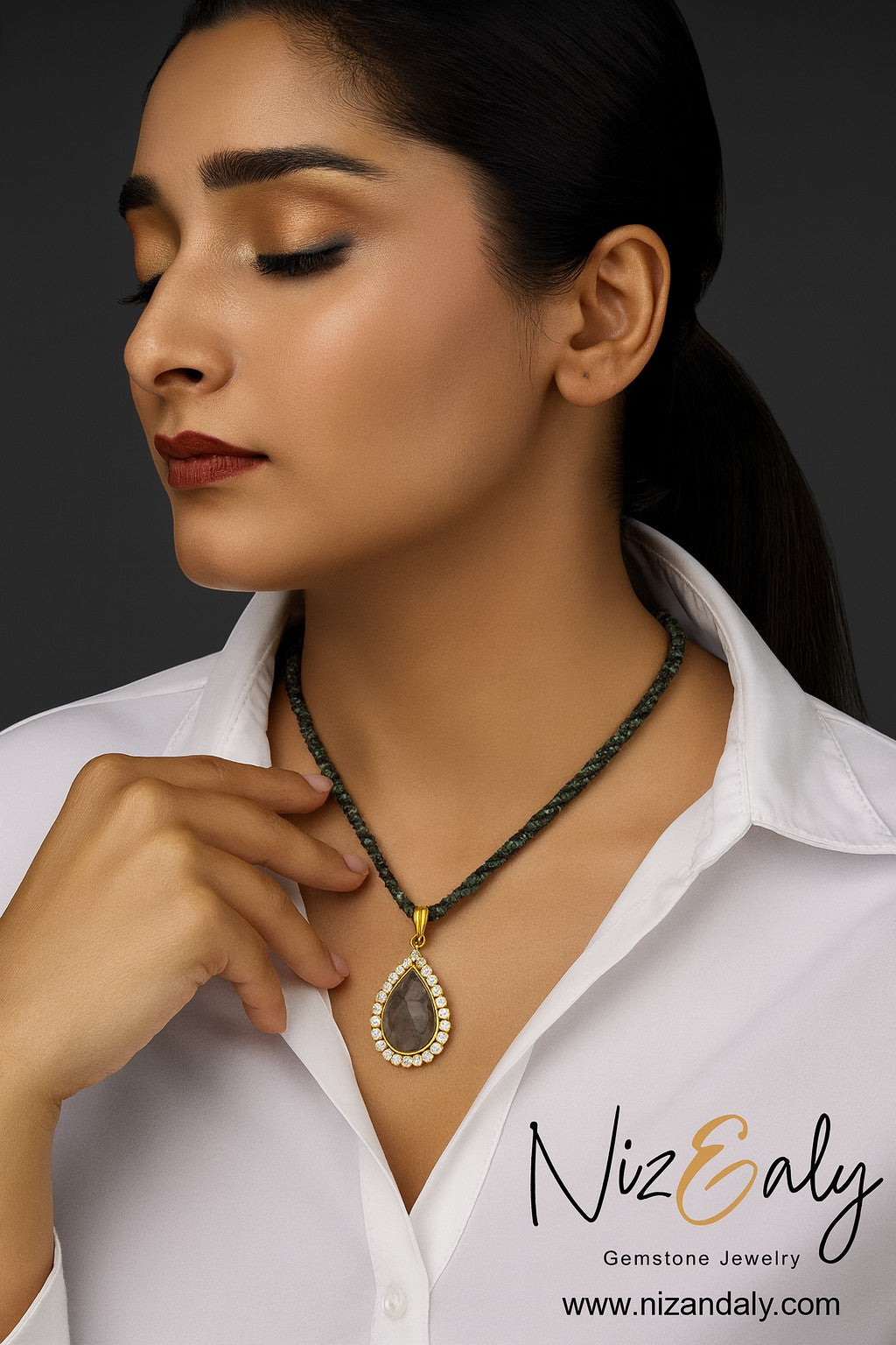 Niz & Aly labradorite teardrop pendant necklace with micro African turquoise beads worn by a woman in a white shirt.