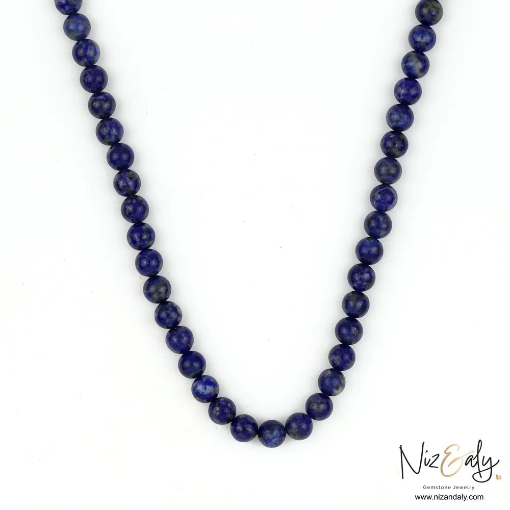 Niz & Aly Midnight Link necklace featuring deep blue lapis lazuli beads with a silver magnetic clasp.