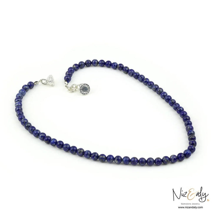 Niz & Aly Midnight Link necklace featuring deep blue lapis lazuli beads and a decorative silver magnetic clasp.