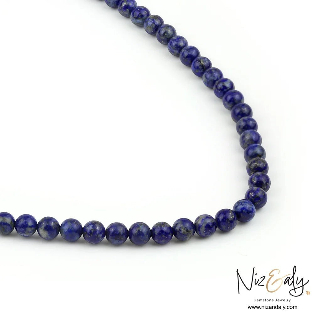 Niz & Aly deep blue lapis lazuli beaded necklace with a smooth, polished finish on a white background.