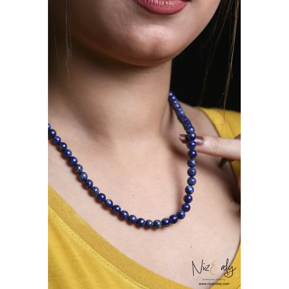 Niz & Aly lapis lazuli beaded necklace with deep blue gemstone beads worn on a model in a yellow top