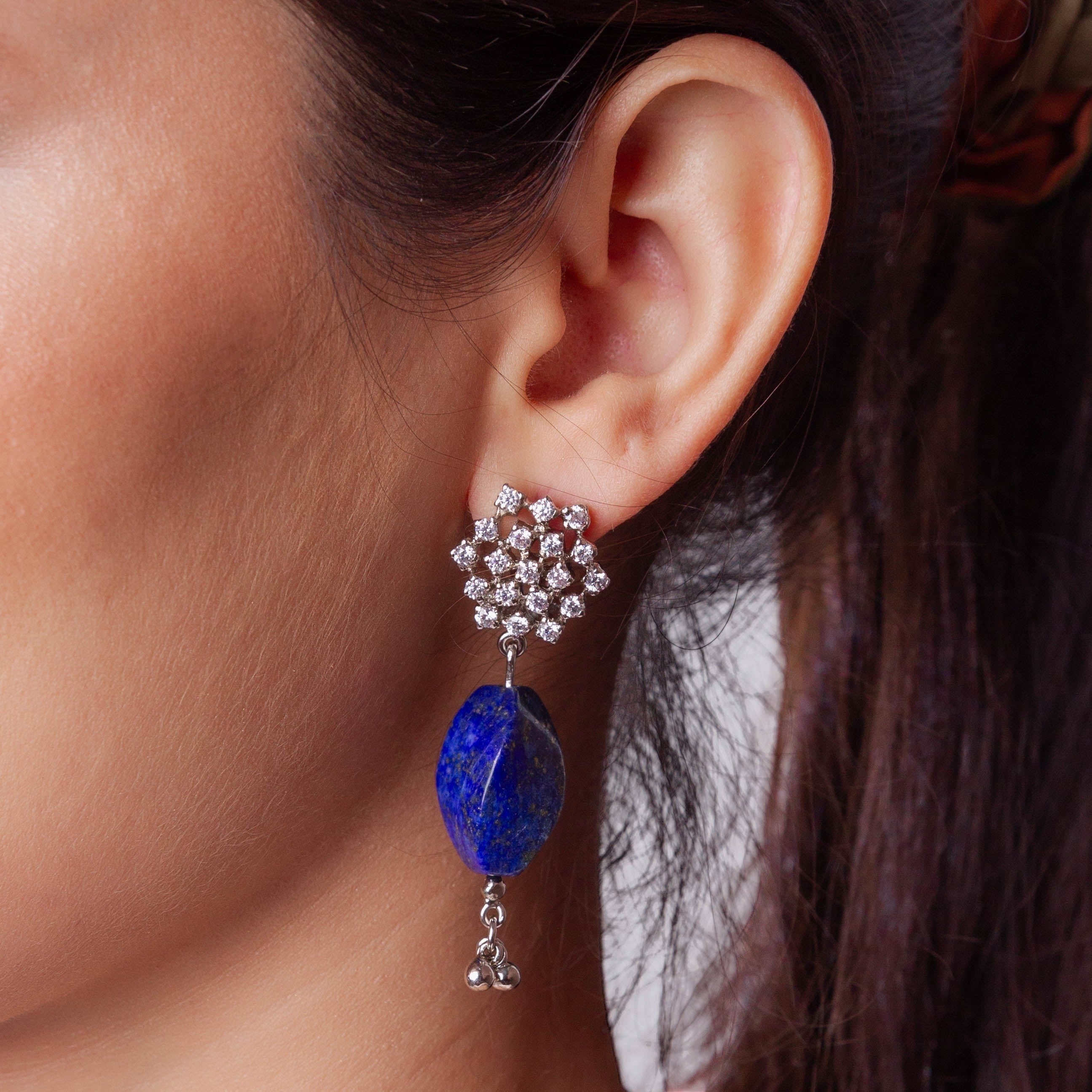 Niz & Aly lapis lazuli drop earring with a floral diamond stud worn on a woman's ear