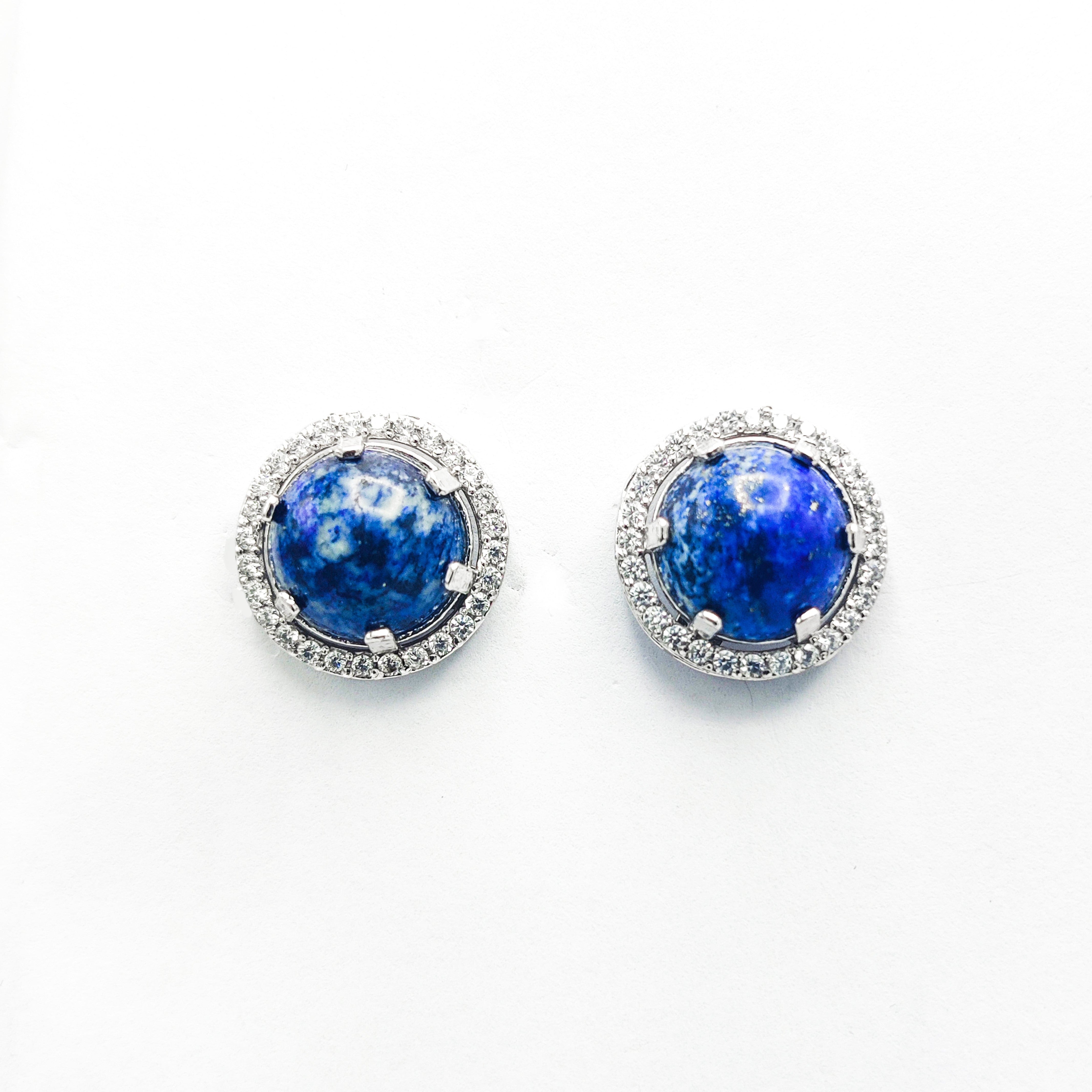 Niz & Aly Celestial Blue Lapis stud earrings featuring round lapis lazuli stones surrounded by a halo of small diamonds.
