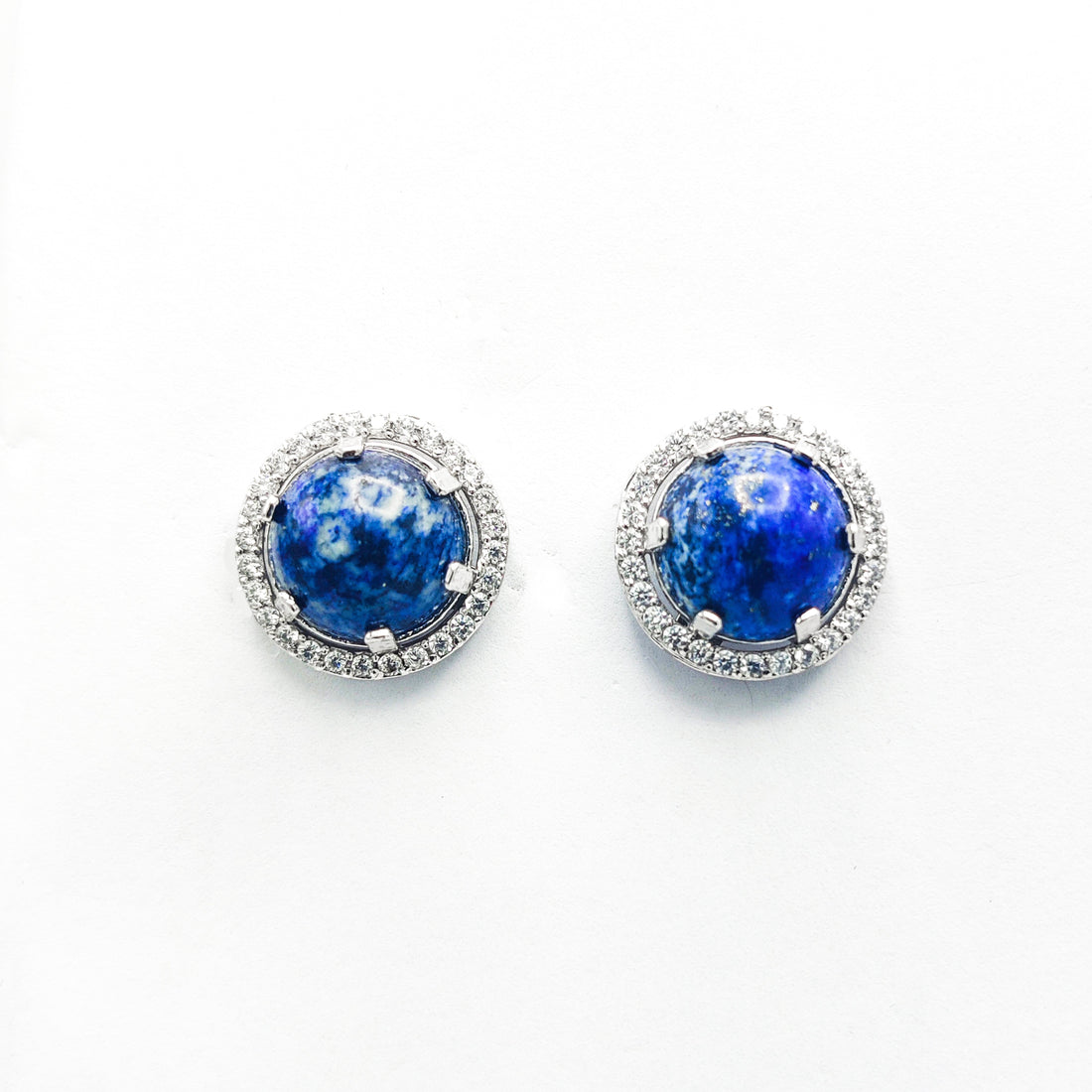 Niz & Aly Celestial Blue Lapis stud earrings featuring round lapis lazuli stones surrounded by a halo of small diamonds.