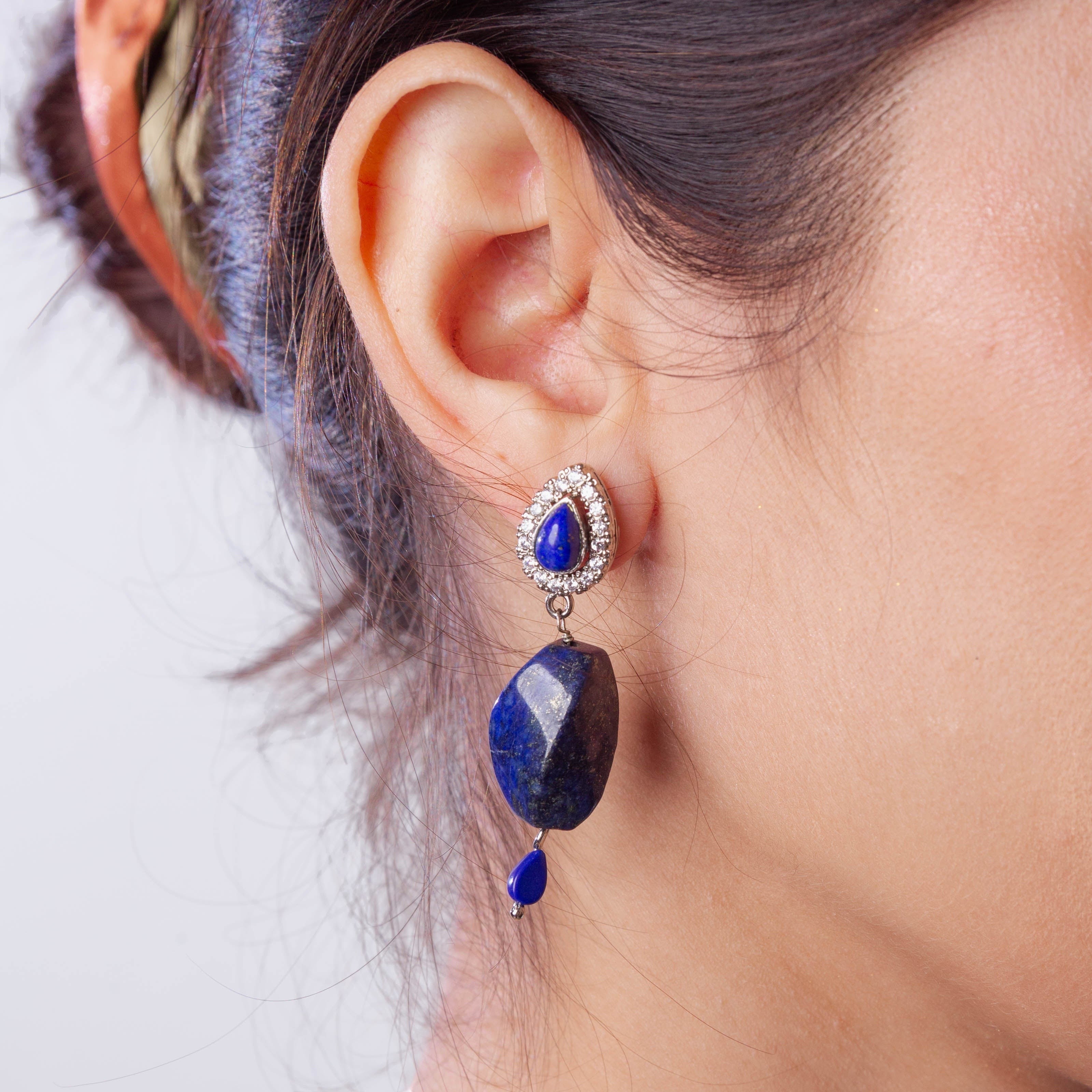Niz & Aly lapis lazuli drop earring with a pear-shaped stone and crystal halo worn on a woman's ear