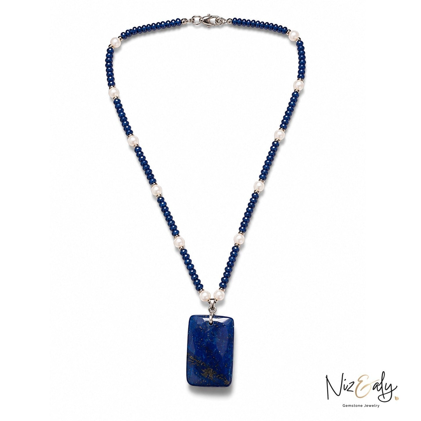 Niz & Aly necklace featuring deep blue lapis lazuli beads, white pearls, and a large rectangular lapis pendant.