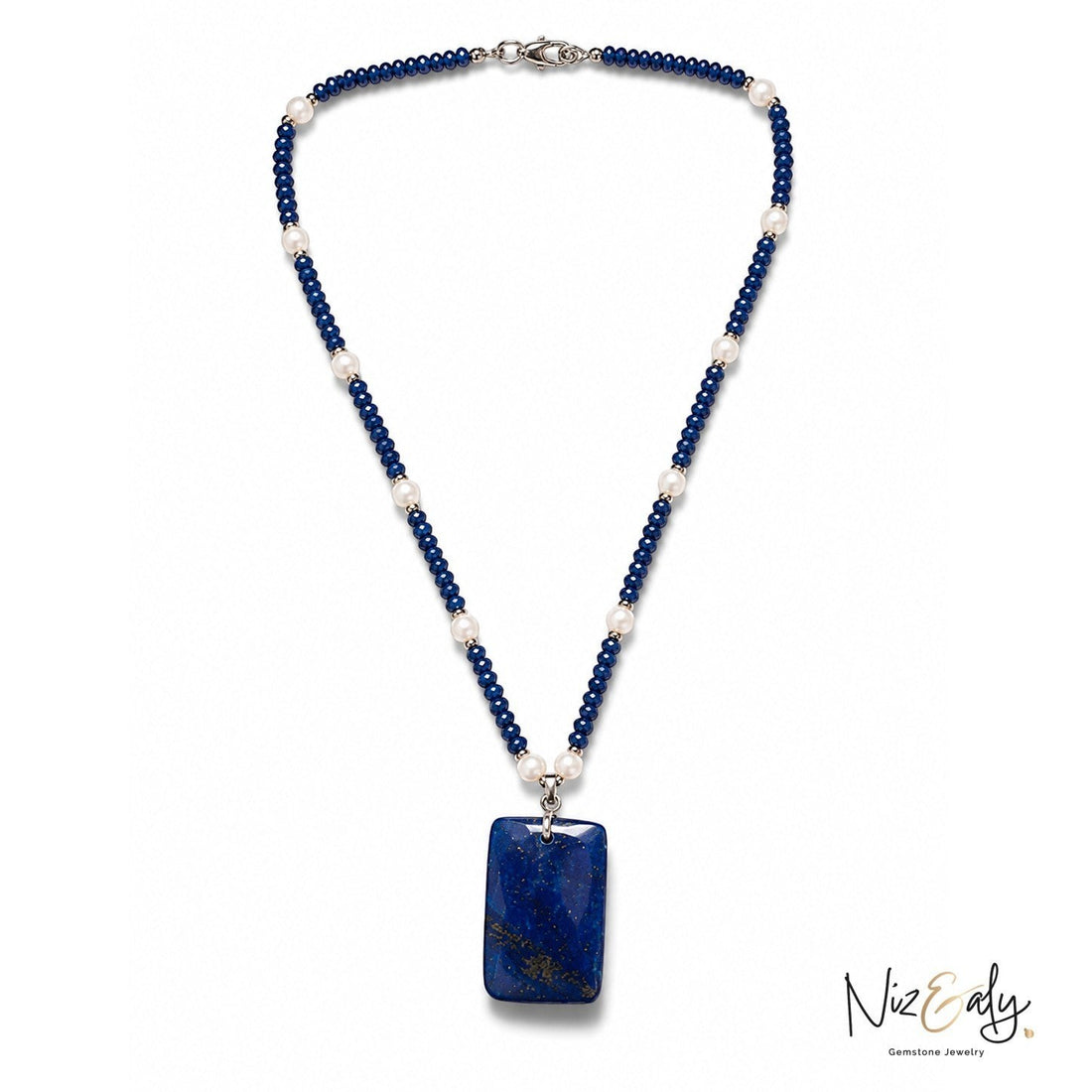 Niz & Aly necklace featuring deep blue lapis lazuli beads, white pearls, and a large rectangular lapis pendant.