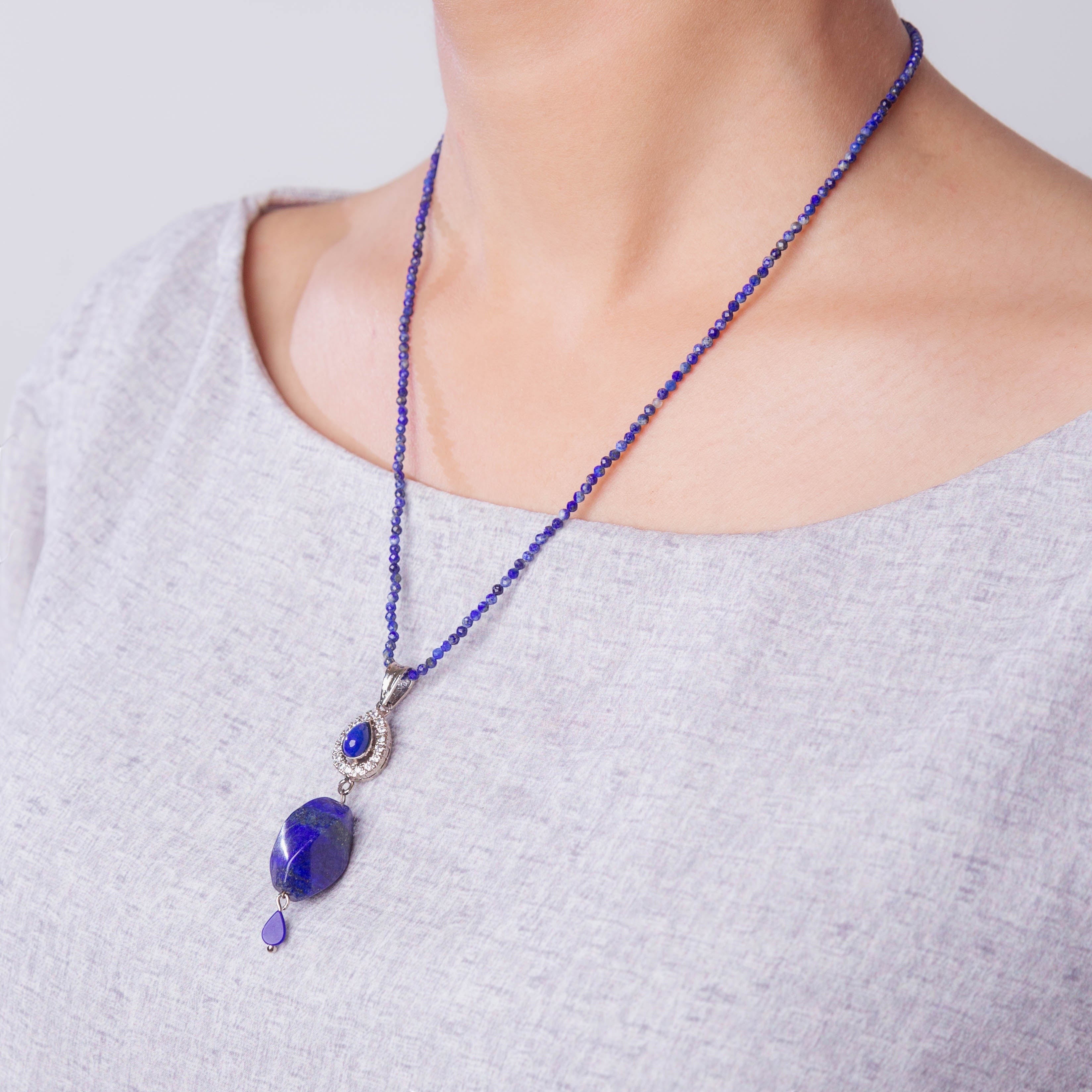 Niz & Aly Lapis Lazuli Delicate Drop Set featuring a deep blue gemstone pendant on a beaded necklace worn by a model.