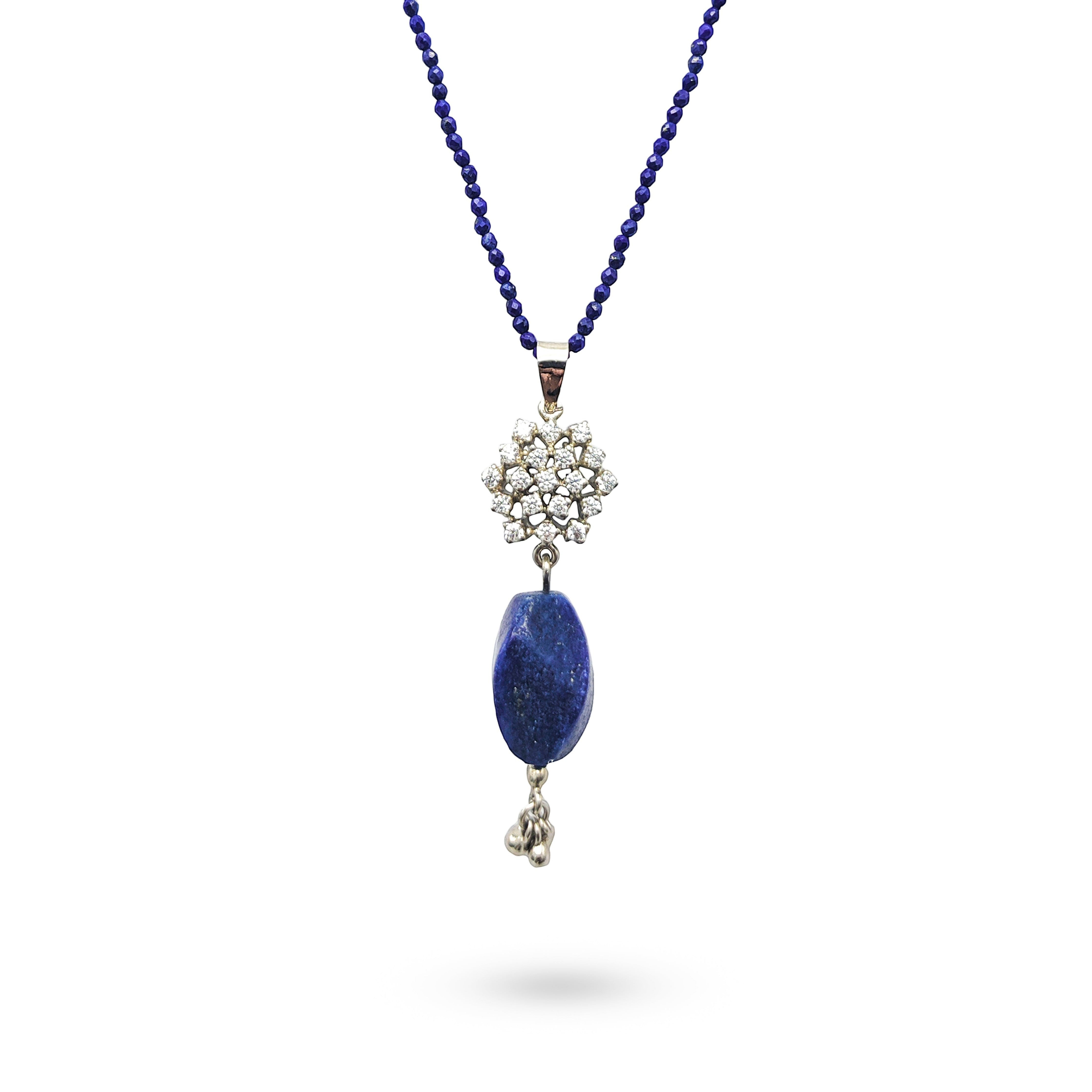 Niz & Aly lapis lazuli pendant on a beaded string with a decorative crystal flower accent and silver drop charm.