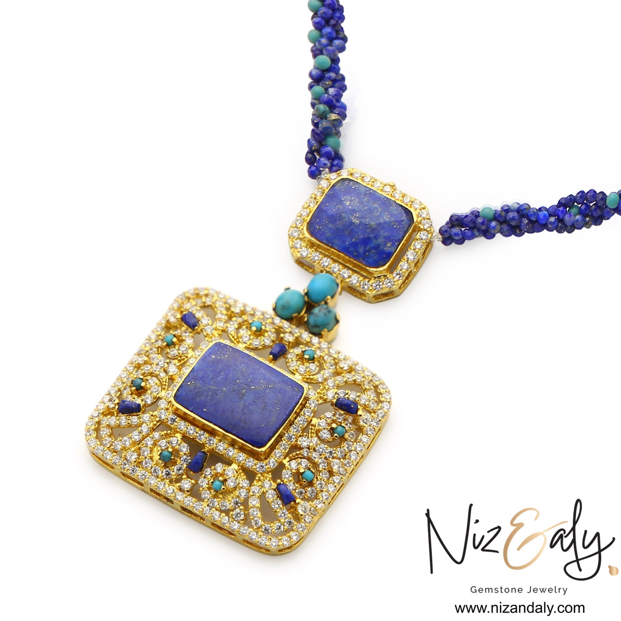 Niz & Aly Blue Monarch statement necklace featuring a square lapis lazuli pendant, turquoise accents, and gold filigree.