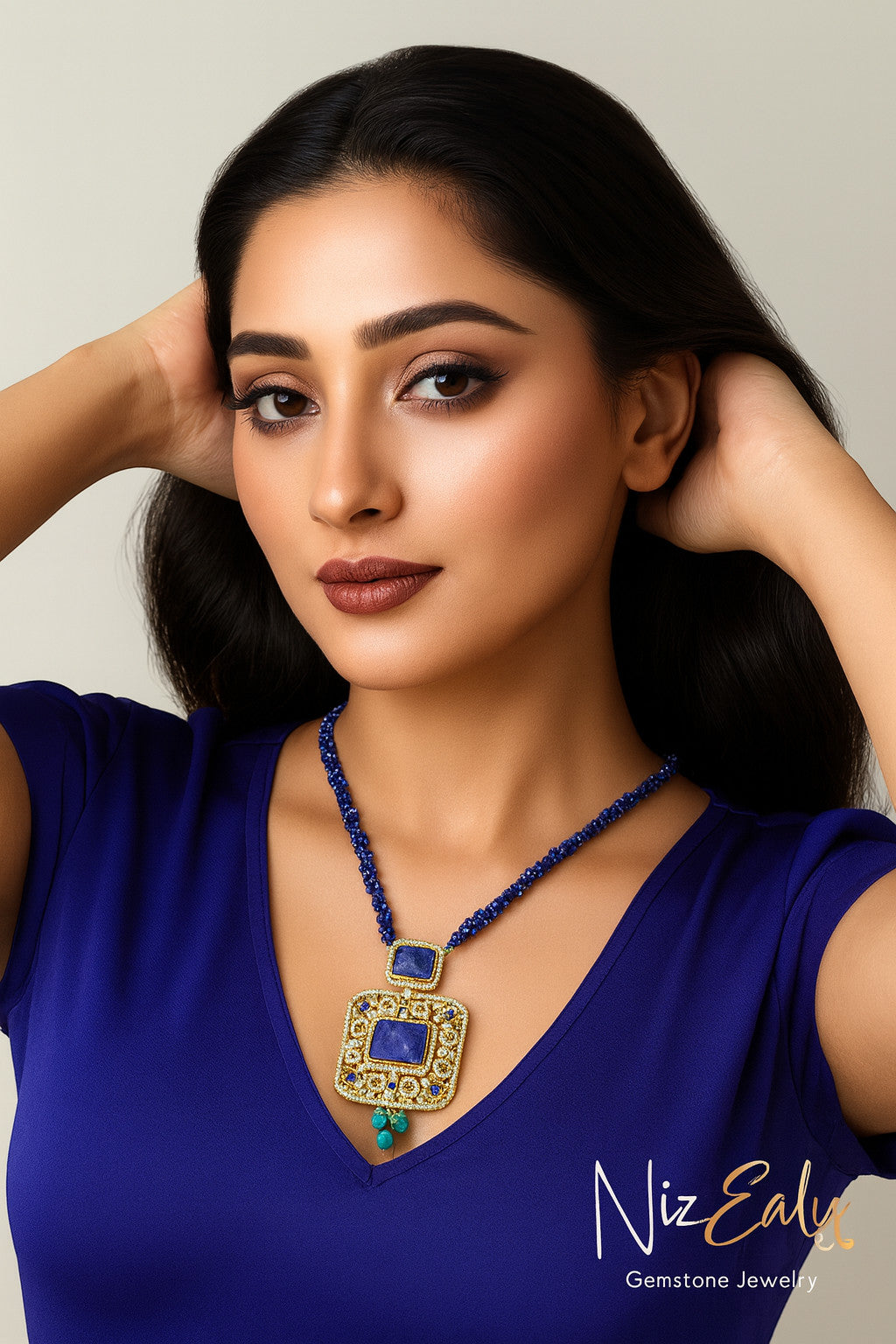 Niz & Aly Blue Monarch statement necklace featuring a square lapis lazuli pendant with turquoise and gold accents.