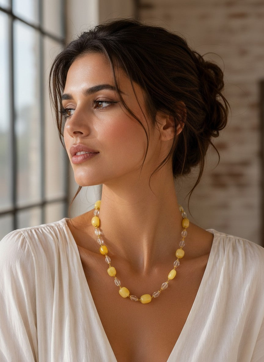 Niz & Aly handcrafted necklace featuring pastel lemon chiffon jade and clear icy quartz beads on a woman.