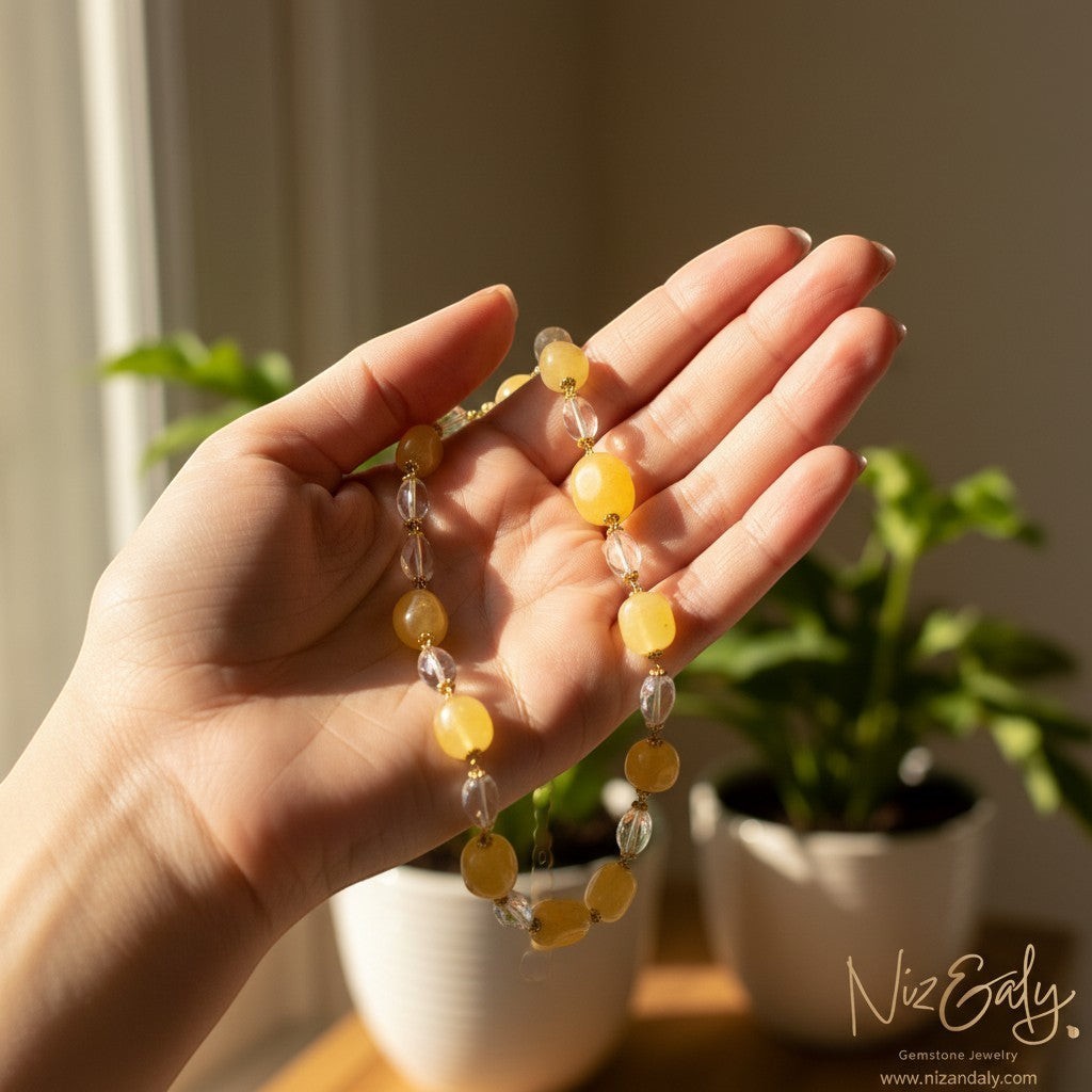 Niz & Aly handcrafted necklace featuring lemon chiffon jade and clear icy quartz beads held in a palm.