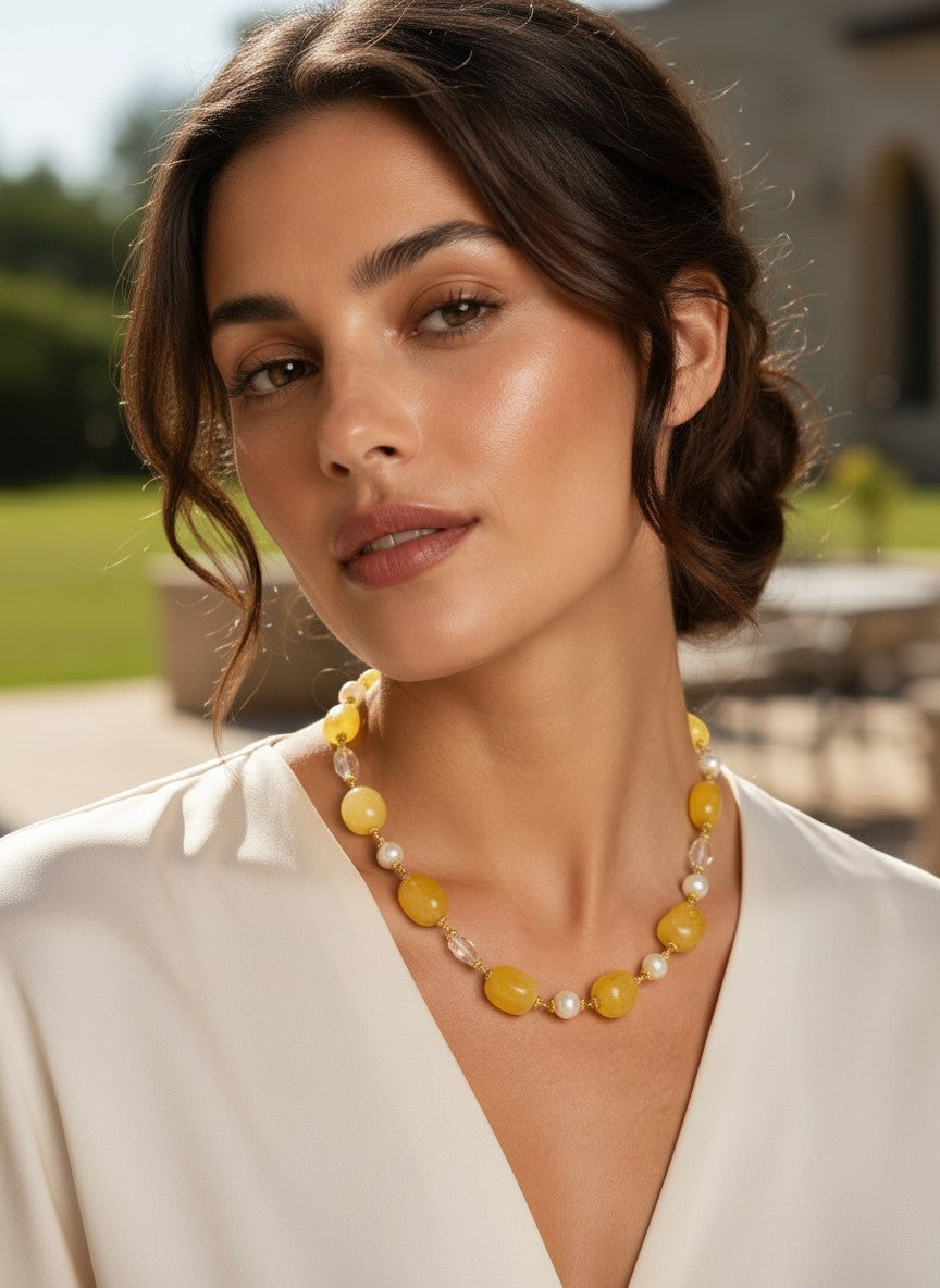 Niz & Aly necklace featuring lemon chiffon jade, icy quartz, and freshwater pearls worn by a woman in a white top.
