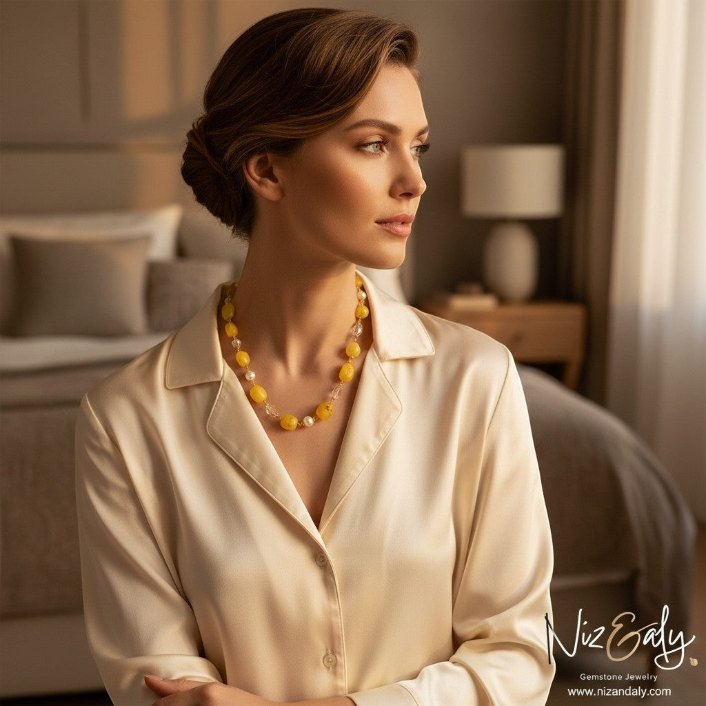 Niz & Aly lemon chiffon jade, icy quartz, and freshwater pearl beaded necklace worn by a woman in a silk blouse.