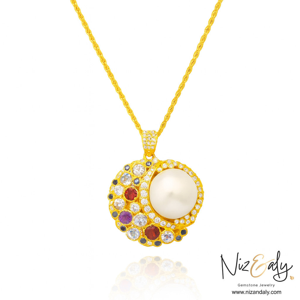 Niz & Aly handcrafted mabe pearl pendant necklace with amethyst, garnet, and blue sapphire on a gold rope chain.