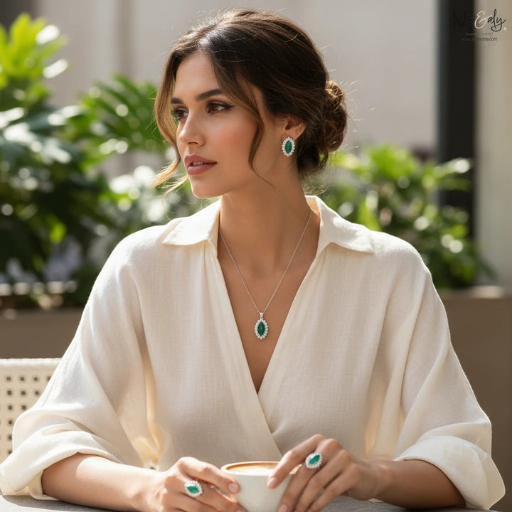 Niz & Aly marquise cut green chrysoprase pendant and earring set worn by a woman in a white blouse