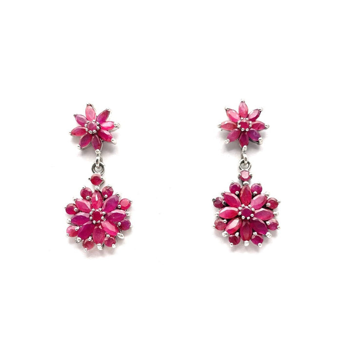 Niz & Aly marquise cut ruby drop earrings featuring floral clusters of deep red gemstones in a silver setting.