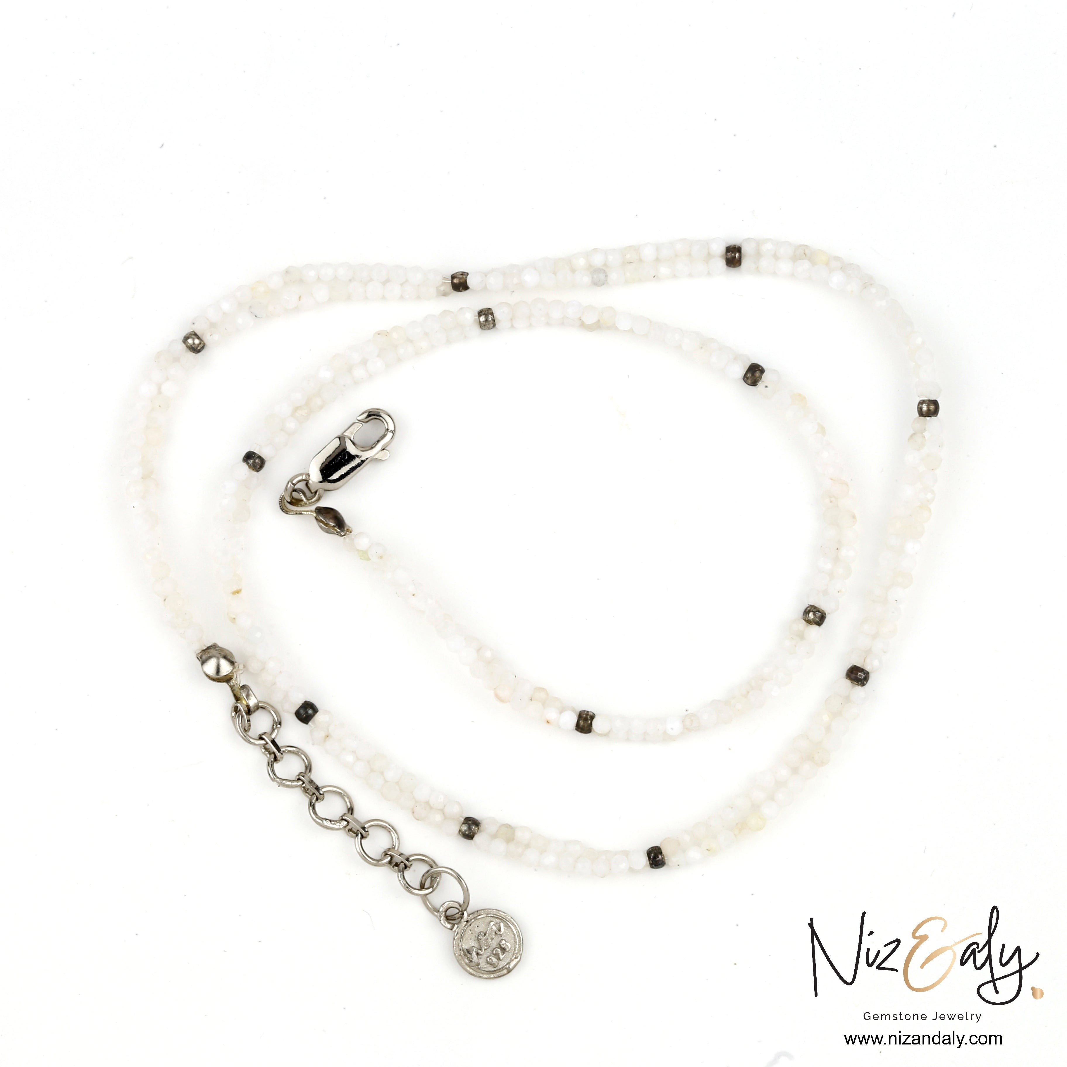 Niz & Aly dainty double string necklace featuring luminous milky quartz beads and silver-tone accents.