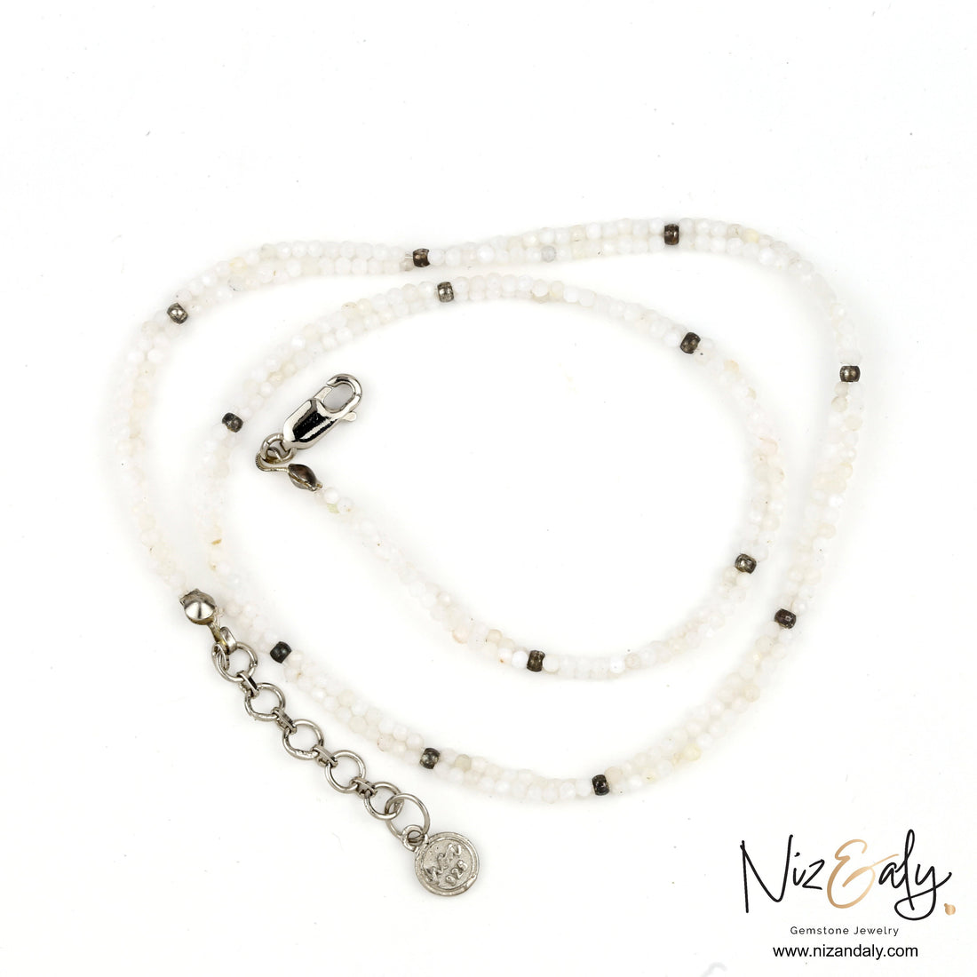 Niz & Aly dainty double string necklace featuring luminous milky quartz beads and silver-tone accents.