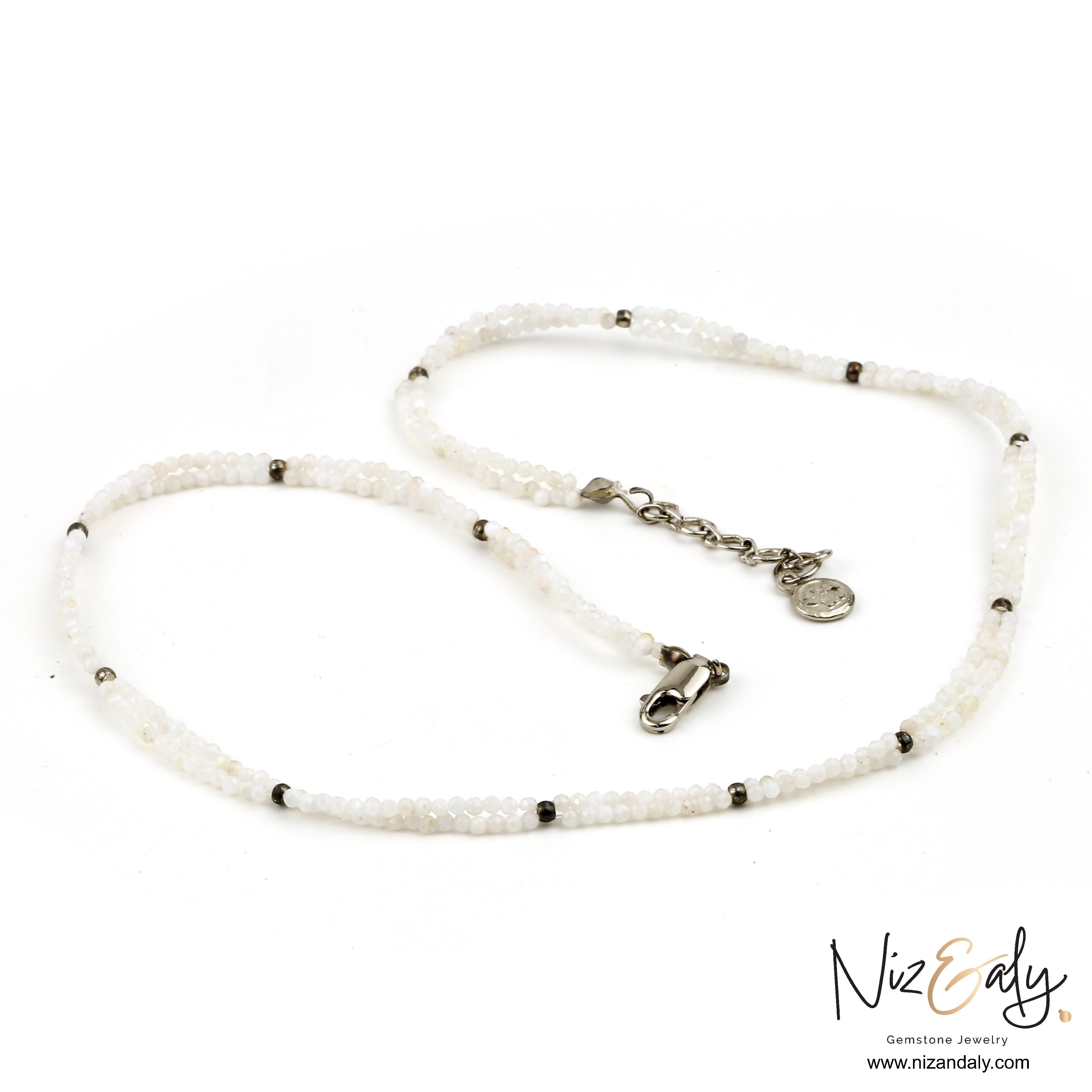 Niz & Aly dainty double-strand necklace featuring luminous milky quartz beads and silver-tone metal accents.