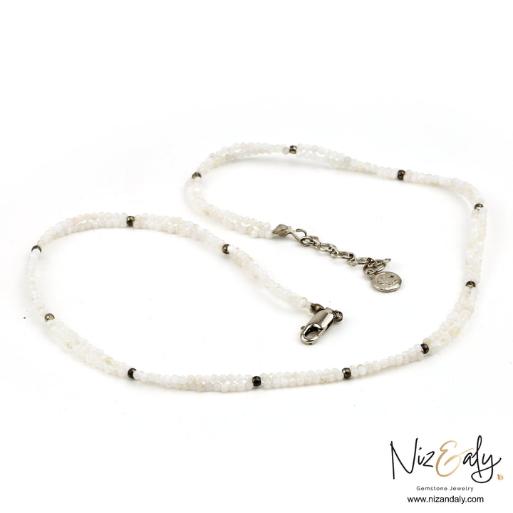 Niz & Aly dainty double-strand necklace featuring luminous milky quartz beads and silver-tone metal accents.