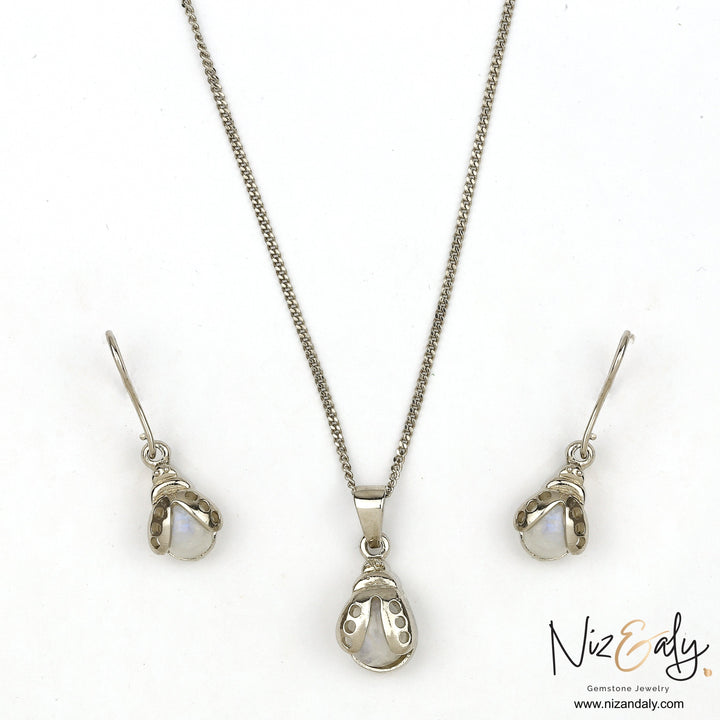 Niz & Aly moonstone bumble bee pendant and earring set in silver with iridescent gemstone accents.