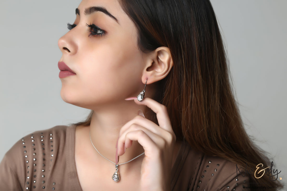 Niz & Aly moonstone bumble bee pendant and earring set worn by a woman, featuring a blue flash gemstone design.