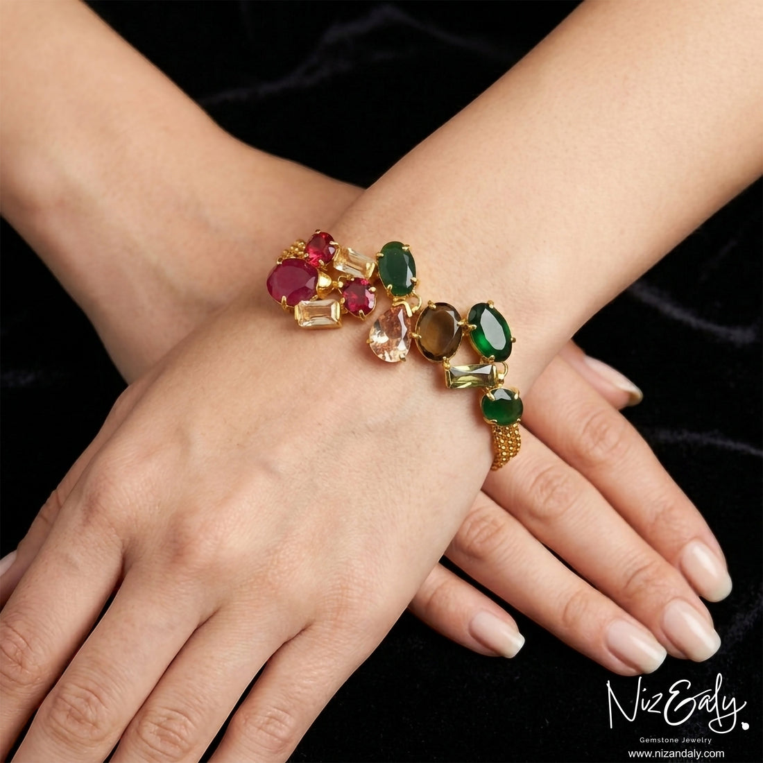 Niz & Aly gold-plated bracelet featuring a pear-shaped composite ruby and multi-colored cubic zirconia gemstones.